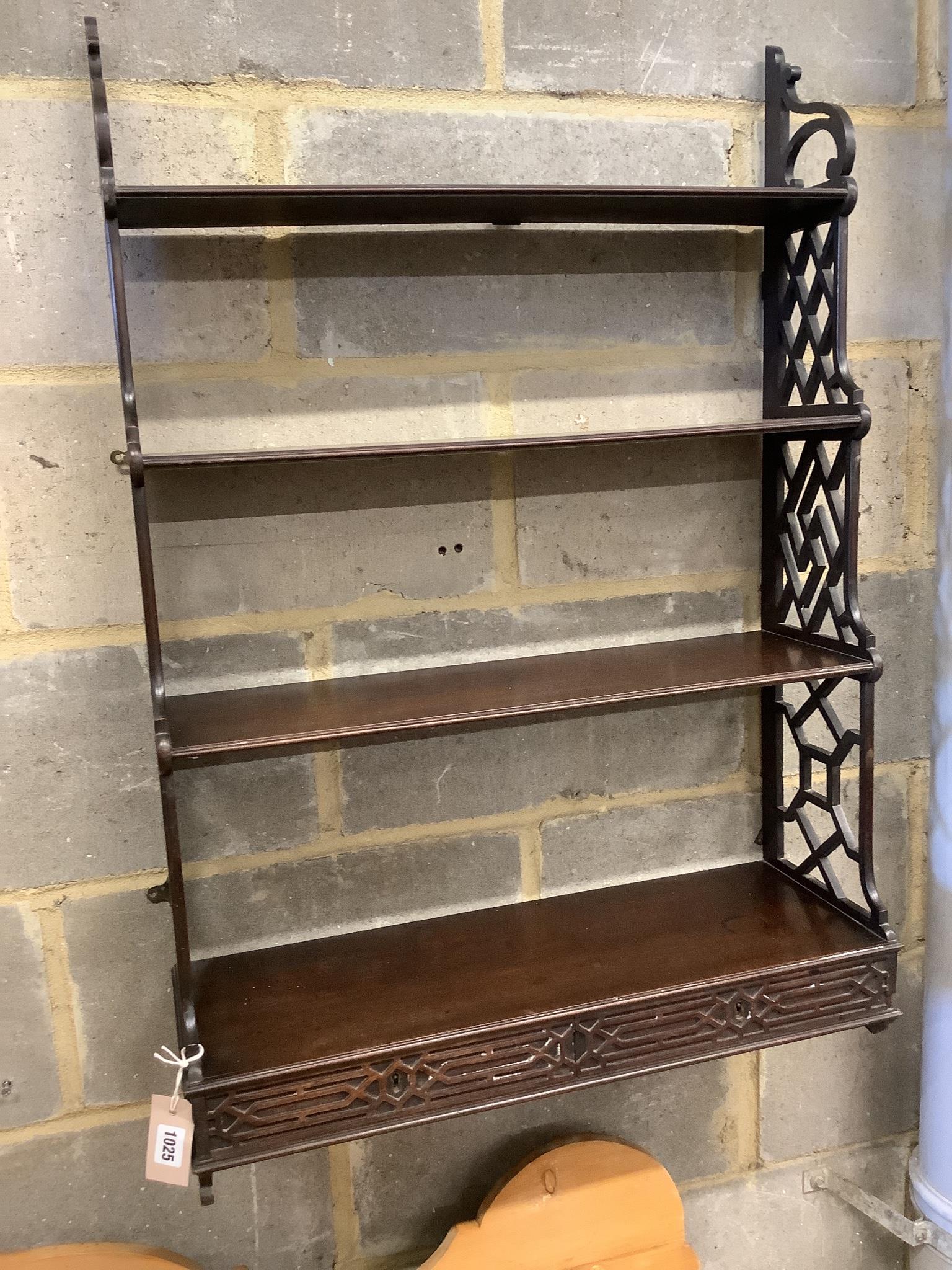 A George III mahogany fret cut four tier wall bracket, width 64cm, depth 22cm, height 94cm